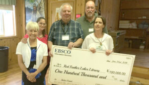 Library Board, Staff, and Friends holding a large-scale grant check from EBSCO corporation.